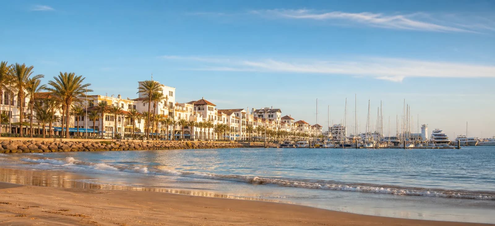 Agadir marina and Atlantic beach with palm-lined waterfront buildings