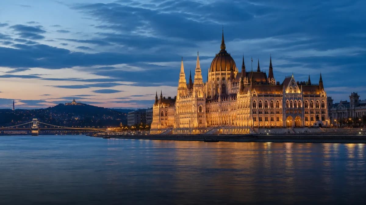 The illuminated Hungarian Parliament beside the Danube in Budapest