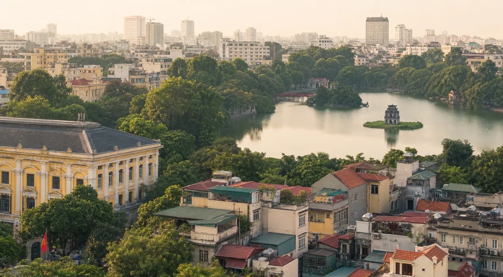 Hanoi rooftops and Hoan Kiem Lake in soft morning light