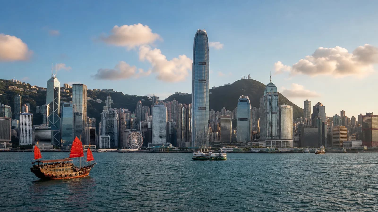 Hong Kong skyline and Victoria Harbour below green island hills