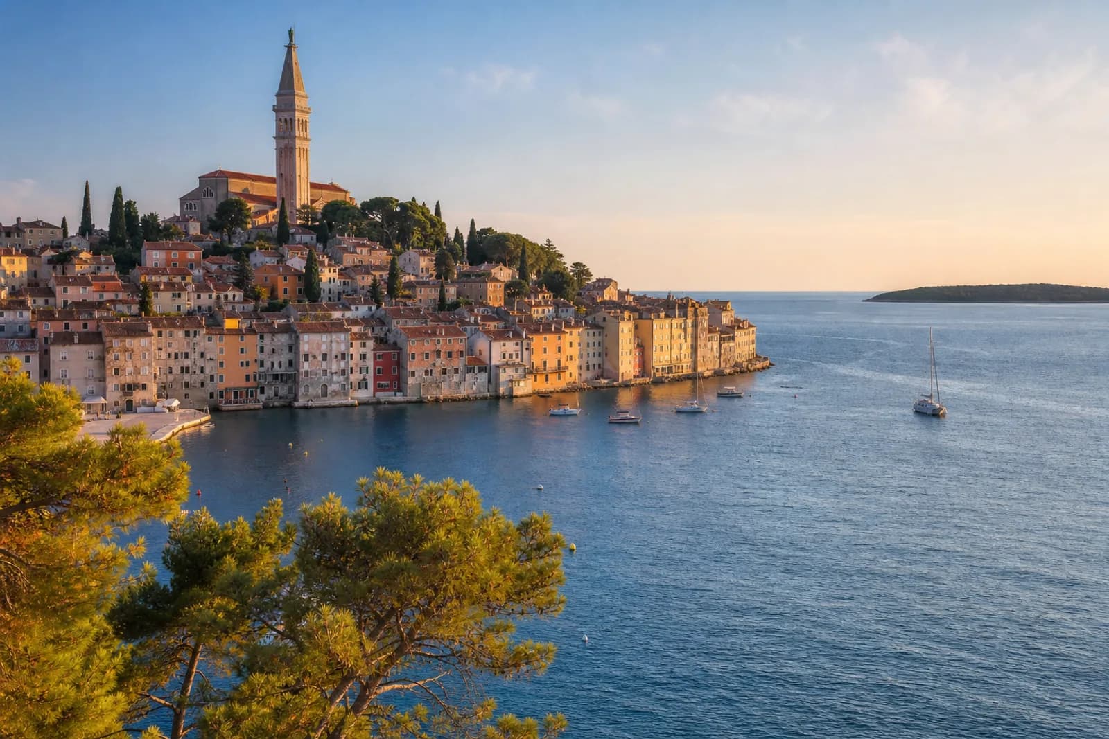 Istrian coastal town rooftops and a church tower above the Adriatic