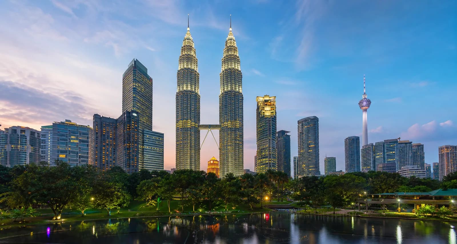 Kuala Lumpur skyline with the Petronas Twin Towers above tropical parkland