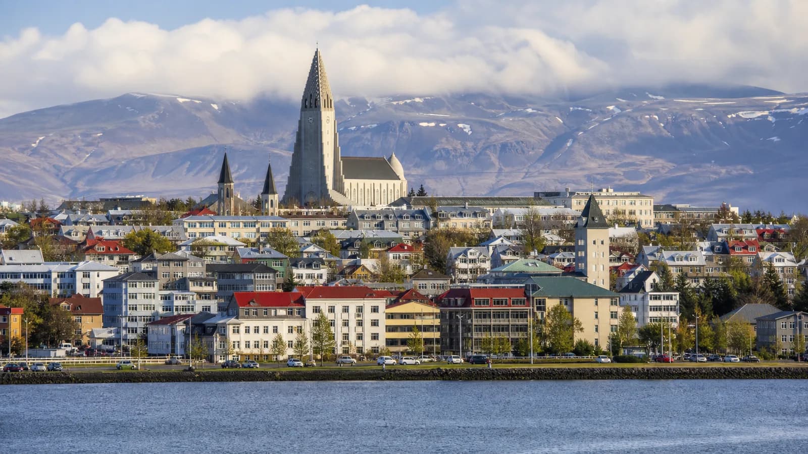 Reykjavik rooftops and Hallgrimskirkja below Icelandic mountains