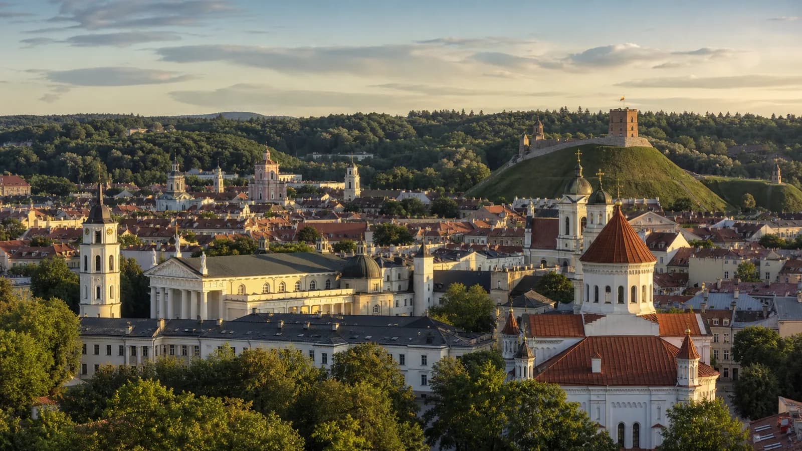 Vilnius old town rooftops and Gediminas Tower above the green castle hill