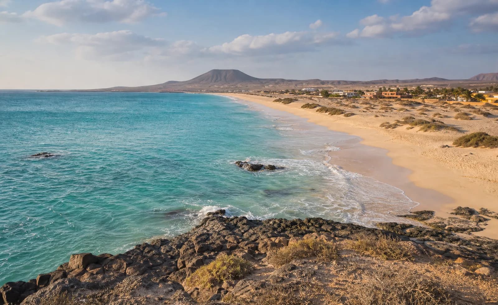 Cape Verde beach and turquoise Atlantic water below dry volcanic hills