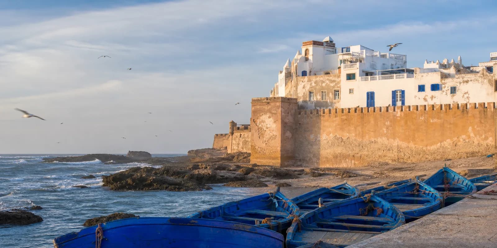 Essaouira sea walls and blue fishing boats beside the Atlantic coast